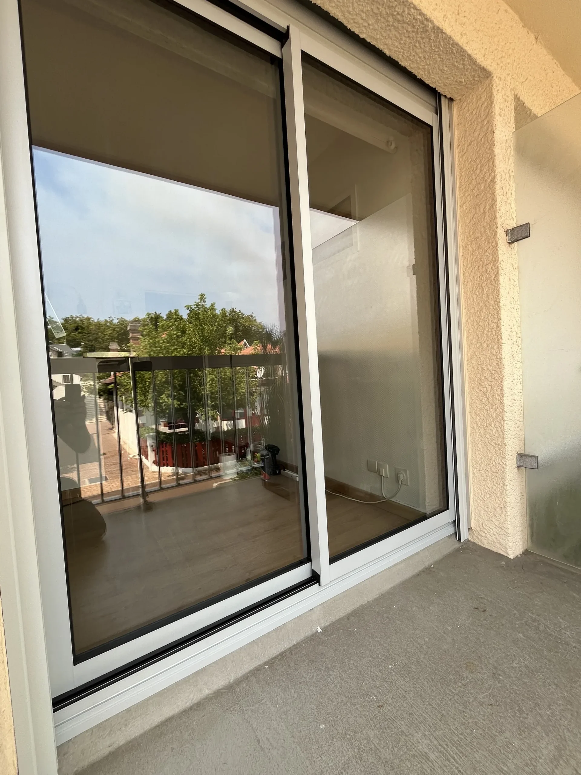 Coulissant aluminium gris clair et pare-vue en verre dépoli sur la loggia